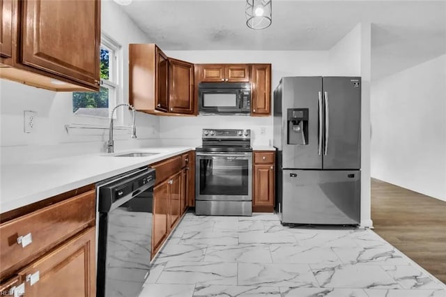 11 Alpine St, Newport News, VA 23606 - kitchen with black appliances, light countertops, brown cabinetry, and light marble finish floors