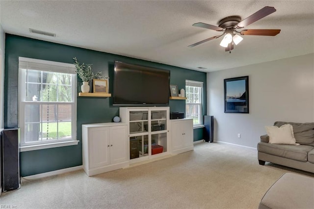 408 Lodge Cv, Chesapeake, VA 23323 - carpeted living area with a textured ceiling, ceiling fan, and healthy amount of natural light