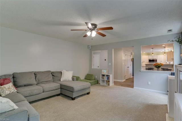 408 Lodge Cv, Chesapeake, VA 23323 - living area with ceiling fan, light carpet, and a textured ceiling