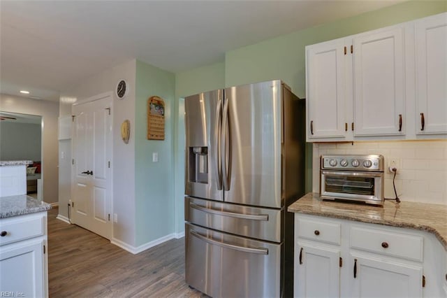 408 Lodge Cv, Chesapeake, VA 23323 - kitchen with stainless steel refrigerator with ice dispenser, wood finished floors, white cabinetry, light stone counters, and recessed lighting