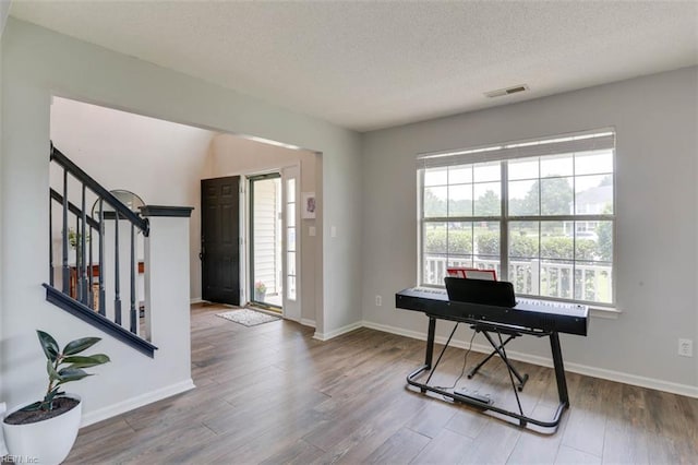 408 Lodge Cv, Chesapeake, VA 23323 - entrance foyer featuring wood finished floors, plenty of natural light, stairs, and a textured ceiling