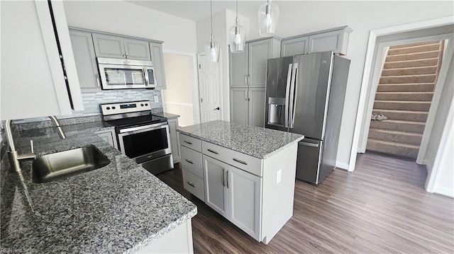 275 Jonathans Way, Suffolk, VA 23434 - kitchen featuring stainless steel appliances, dark wood-style floors, light stone countertops, a kitchen island, and gray cabinets
