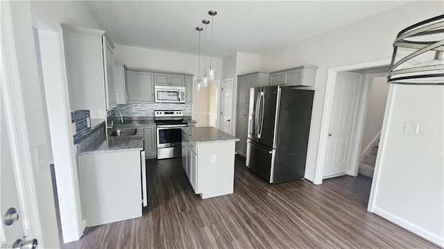 275 Jonathans Way, Suffolk, VA 23434 - kitchen featuring stainless steel appliances, gray cabinets, a center island, dark wood-style flooring, and decorative backsplash
