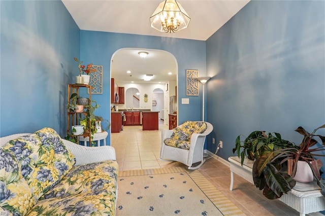 4208 Falcon Creek Dr, Williamsburg, VA 23188 - living area featuring arched walkways, light tile patterned floors, and a chandelier