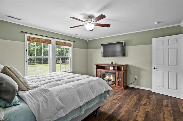 114 Climbing Vine Run, Elizabeth City, NC 27909 - bedroom with dark wood-style floors, crown molding, a glass covered fireplace, and ceiling fan