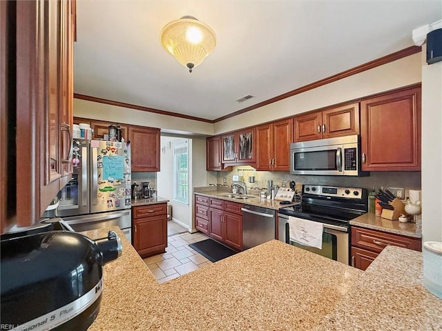 719 Kensington Dr, Newport News, VA 23602 - kitchen featuring stainless steel appliances, ornamental molding, backsplash, light tile patterned flooring, and brown cabinets