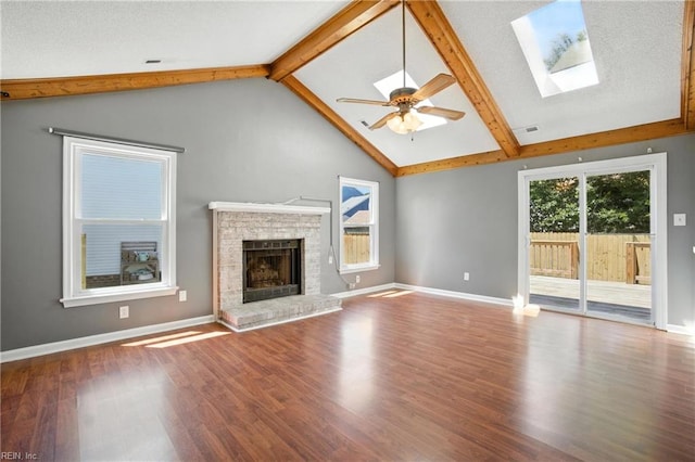 1220 Brahms Dr, Virginia Beach, VA 23454 - unfurnished living room featuring a fireplace, wood finished floors, ceiling fan, and a skylight