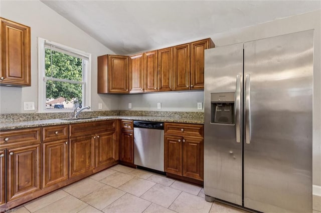 149 Ransone St, Hampton, VA 23669 - kitchen featuring stainless steel appliances, vaulted ceiling, light stone counters, light tile patterned floors, and brown cabinetry