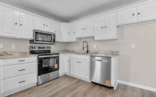 3549 Dandelion Cres, Virginia Beach, VA 23453 - kitchen with stainless steel appliances, light wood-type flooring, white cabinets, and light stone countertops