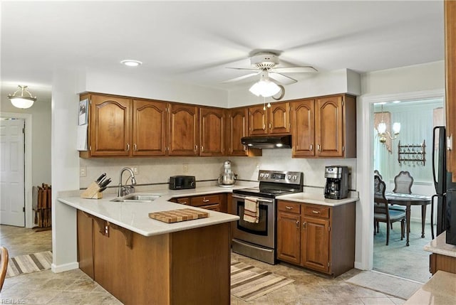 3805 Fleet Ct, Portsmouth, VA 23703 - kitchen with stainless steel range with electric stovetop, under cabinet range hood, a peninsula, ceiling fan, and light countertops