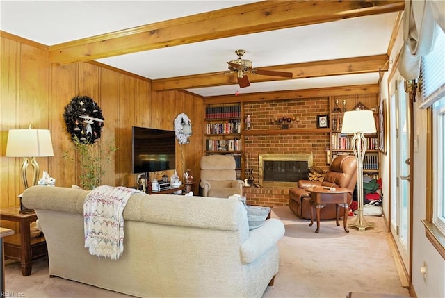 3805 Fleet Ct, Portsmouth, VA 23703 - living room featuring light colored carpet, beamed ceiling, wooden walls, ceiling fan, and a fireplace