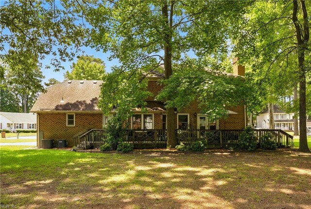 3805 Fleet Ct, Portsmouth, VA 23703 - rear view of property featuring brick siding, a chimney, a wooden deck, and a yard