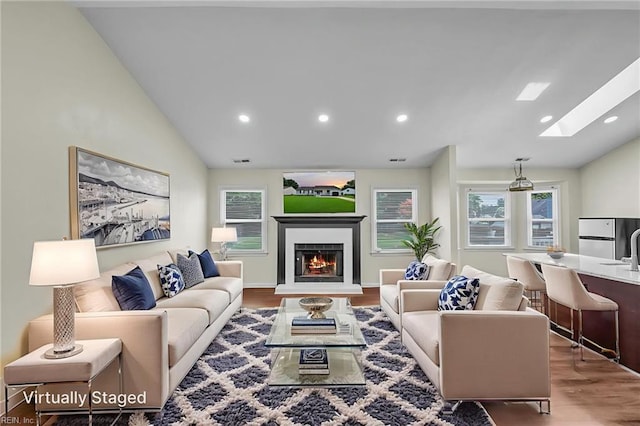 2416 Broadnax Cir, Chesapeake, VA 23323 - living room with lofted ceiling, wood finished floors, a skylight, recessed lighting, and a lit fireplace