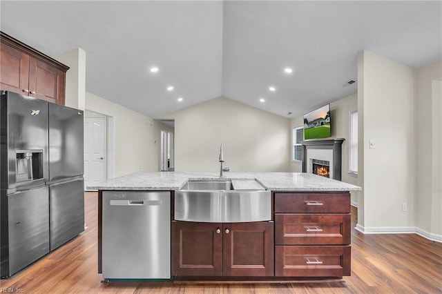 2416 Broadnax Cir, Chesapeake, VA 23323 - kitchen with stainless steel appliances, wood finished floors, light stone countertops, a lit fireplace, and vaulted ceiling