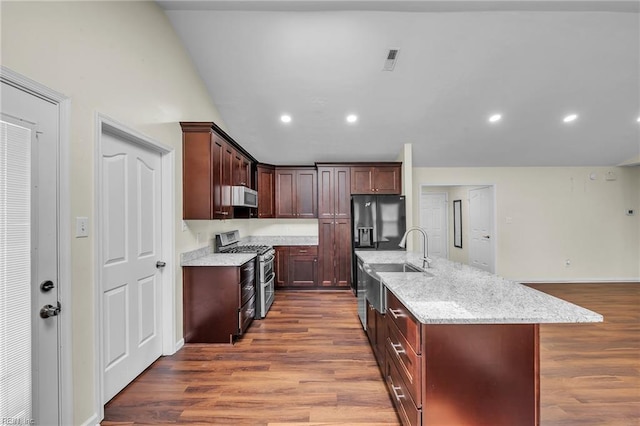 2416 Broadnax Cir, Chesapeake, VA 23323 - kitchen featuring range with two ovens, dark wood-style flooring, extractor fan, refrigerator with ice dispenser, and light stone counters