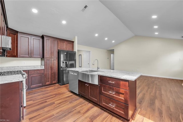 2416 Broadnax Cir, Chesapeake, VA 23323 - kitchen with stainless steel appliances, lofted ceiling, light wood finished floors, a kitchen island with sink, and recessed lighting