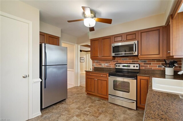 2513 Torrey Pl, Virginia Beach, VA 23454 - kitchen with appliances with stainless steel finishes, brown cabinets, ceiling fan, and tasteful backsplash