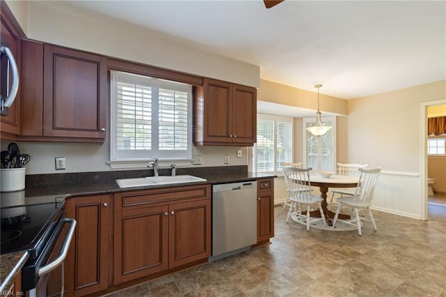 2513 Torrey Pl, Virginia Beach, VA 23454 - kitchen featuring appliances with stainless steel finishes, dark countertops, pendant lighting, a wainscoted wall, and brown cabinets