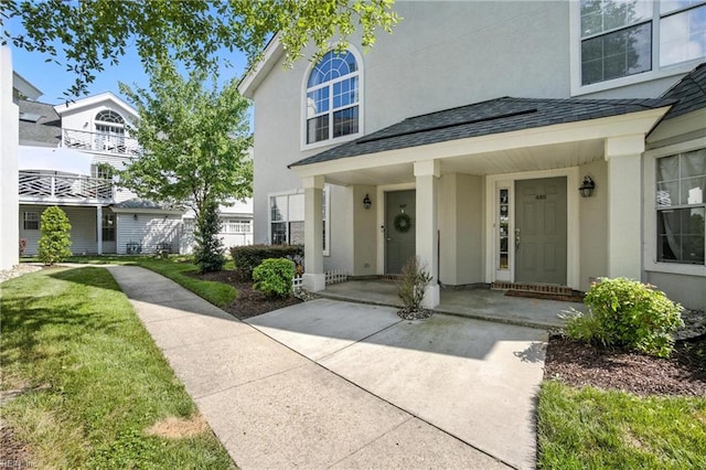 447 Seahorse Run, Chesapeake, VA 23320 - doorway to property featuring stucco siding, a yard, and a porch