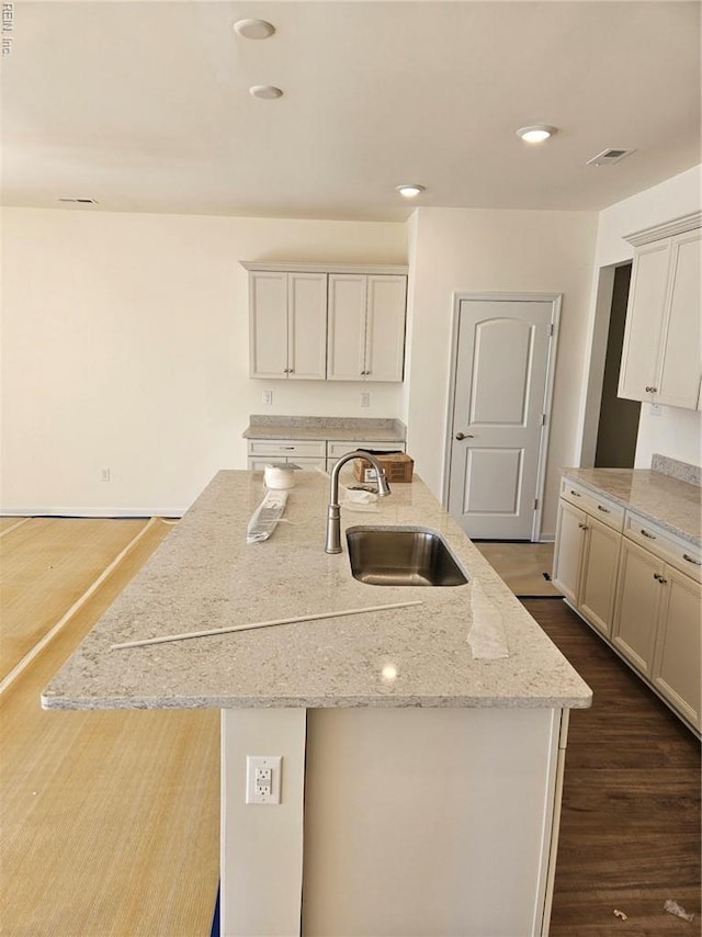 208 St Pauls Ave Unit 30-3, Smithfield, VA 23430 - kitchen with dark wood finished floors, light stone counters, an island with sink, and recessed lighting