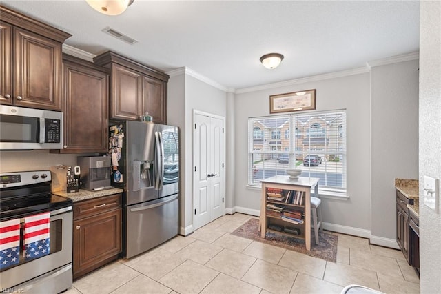 7546 Villa Ct Unit 37, Gloucester Point, VA 23062 - kitchen featuring stainless steel appliances, crown molding, light stone counters, light tile patterned floors, and dark brown cabinets
