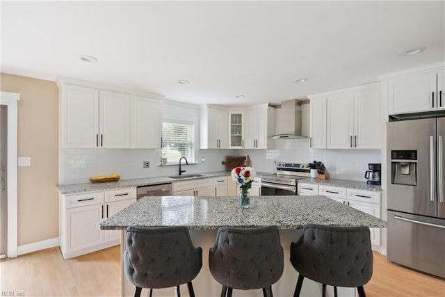 6019 Tabiatha Ln, Lanexa, VA 23089 - kitchen featuring stainless steel appliances, wall chimney exhaust hood, a breakfast bar area, decorative backsplash, and recessed lighting