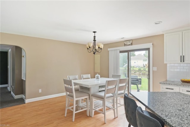 6019 Tabiatha Ln, Lanexa, VA 23089 - dining area with a chandelier, arched walkways, and light wood finished floors