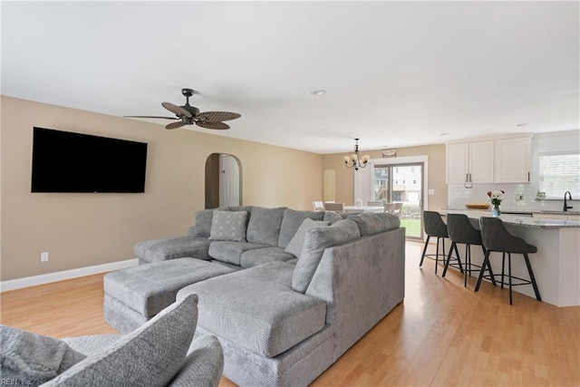 6019 Tabiatha Ln, Lanexa, VA 23089 - living area with light wood-style floors, a chandelier, a ceiling fan, and arched walkways