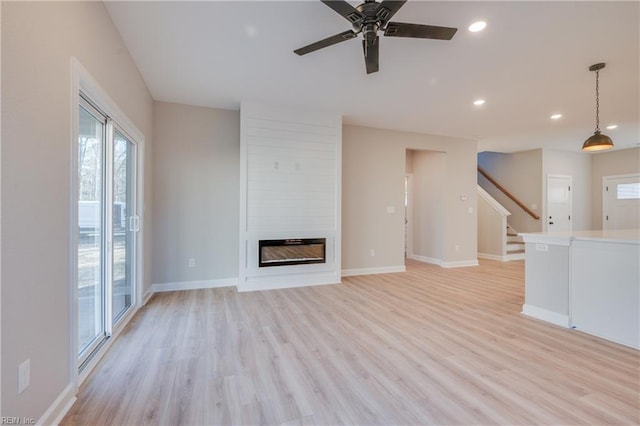 120 Rowland Creek Rd, Moyock, NC 27958 - unfurnished living room featuring stairs, recessed lighting, light wood-type flooring, ceiling fan, and a fireplace