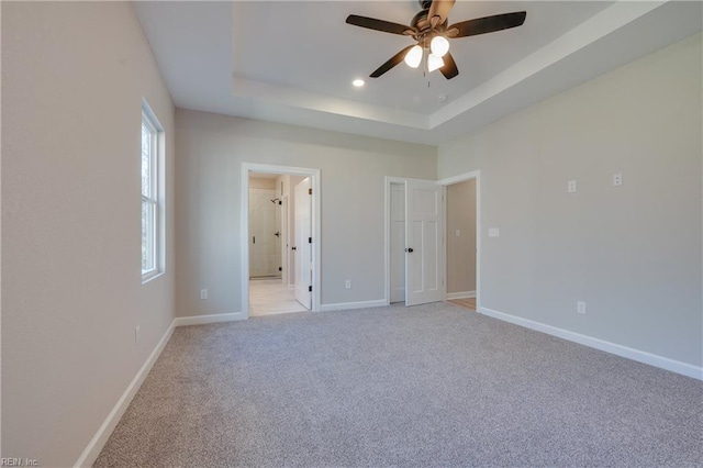 120 Rowland Creek Rd, Moyock, NC 27958 - unfurnished bedroom with a raised ceiling, light carpet, recessed lighting, ensuite bathroom, and a ceiling fan