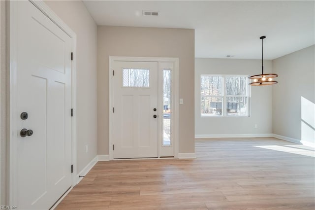 120 Rowland Creek Rd, Moyock, NC 27958 - entrance foyer with light wood-style floors and a chandelier