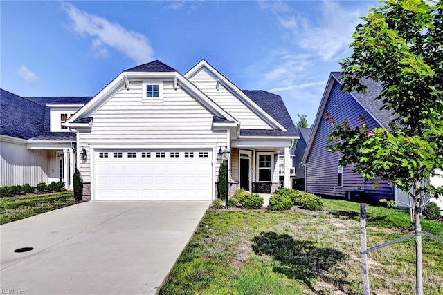 6371 Yarmouth Run, Williamsburg, VA 23188 - view of front of property featuring concrete driveway, stone siding, a garage, and a front lawn