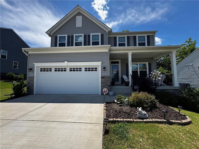 9809 Coral Bells Ct, Toano, VA 23168 - view of front facade with driveway, stone siding, and covered porch
