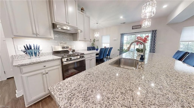 9809 Coral Bells Ct, Toano, VA 23168 - kitchen featuring stainless steel range with gas cooktop, under cabinet range hood, light stone counters, and tasteful backsplash