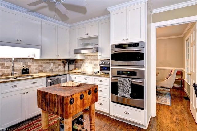 102 Whitehall Ct, Williamsburg, VA 23188 - kitchen featuring appliances with stainless steel finishes, dark wood-style flooring, white cabinetry, tasteful backsplash, and light stone countertops