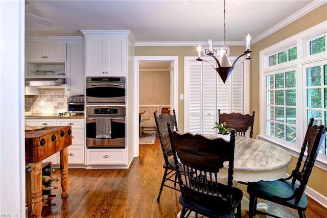 102 Whitehall Ct, Williamsburg, VA 23188 - dining space with dark wood finished floors, ornamental molding, and a chandelier
