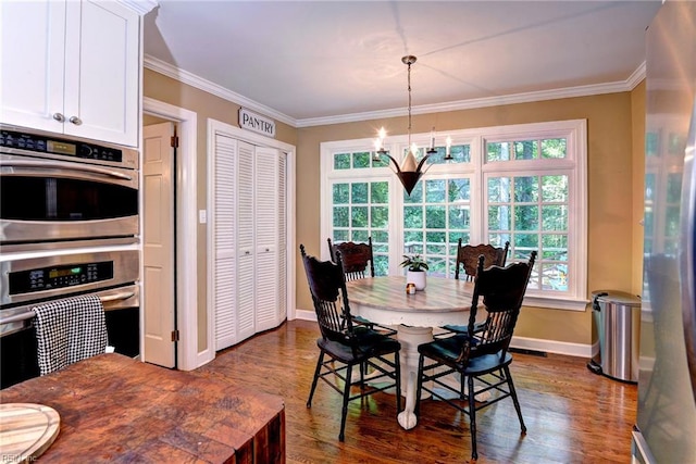 102 Whitehall Ct, Williamsburg, VA 23188 - dining space featuring dark wood-style floors, healthy amount of natural light, ornamental molding, and a chandelier