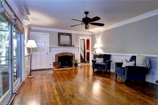102 Whitehall Ct, Williamsburg, VA 23188 - living area with a wainscoted wall, a fireplace, wood finished floors, a ceiling fan, and ornamental molding