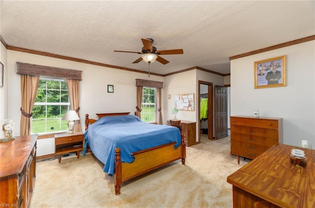2501 Clancie Rd, Shacklefords, VA 23156 - bedroom featuring light carpet, crown molding, a ceiling fan, a walk in closet, and a textured ceiling