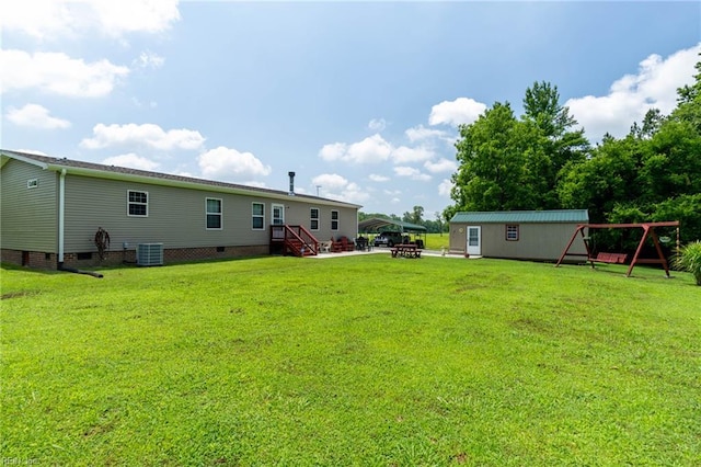 2501 Clancie Rd, Shacklefords, VA 23156 - view of green lawn featuring an outdoor structure, a fire pit, and a patio area