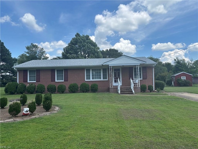906 Rebecca St, Franklin, VA 23851 - ranch-style house with a porch, a front lawn, and brick siding
