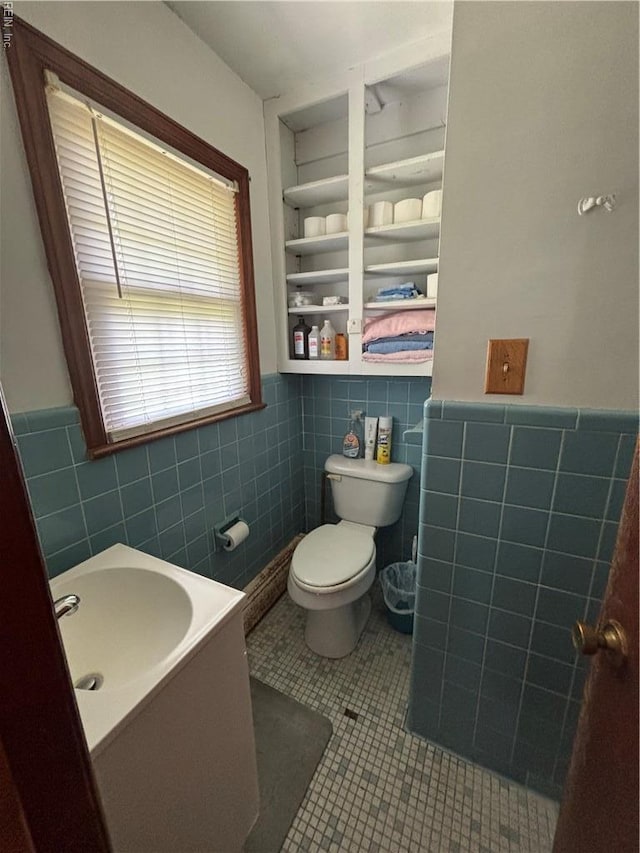906 Rebecca St, Franklin, VA 23851 - bathroom with tile walls, a wainscoted wall, built in shelves, tile patterned flooring, and vanity