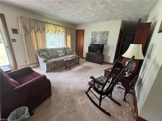 906 Rebecca St, Franklin, VA 23851 - living area with baseboard heating, light colored carpet, and a textured ceiling