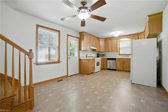 6 Albemarle St, Portsmouth, VA 23707 - kitchen with appliances with stainless steel finishes, under cabinet range hood, light countertops, and a ceiling fan