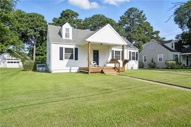 6 Albemarle St, Portsmouth, VA 23707 - view of front of home with a porch, a front lawn, a detached garage, and a shingled roof