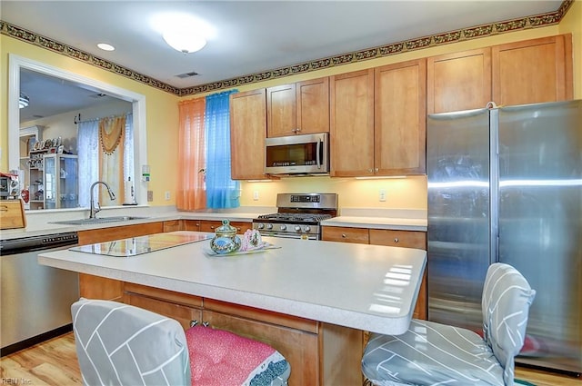 1132 Broadholme Pl Unit 642, Virginia Beach, VA 23455 - kitchen featuring stainless steel appliances, light countertops, a breakfast bar area, and brown cabinetry