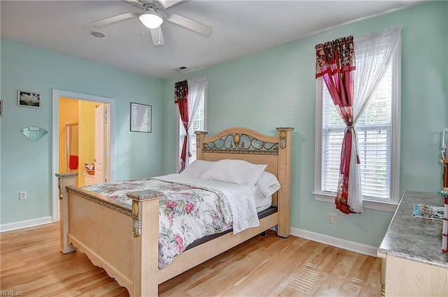 1132 Broadholme Pl Unit 642, Virginia Beach, VA 23455 - bedroom with light wood finished floors, multiple windows, a ceiling fan, and ensuite bathroom