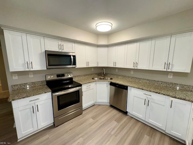 2020 Lyndora Rd, Virginia Beach, VA 23464 - kitchen featuring appliances with stainless steel finishes, white cabinetry, light wood finished floors, and stone counters
