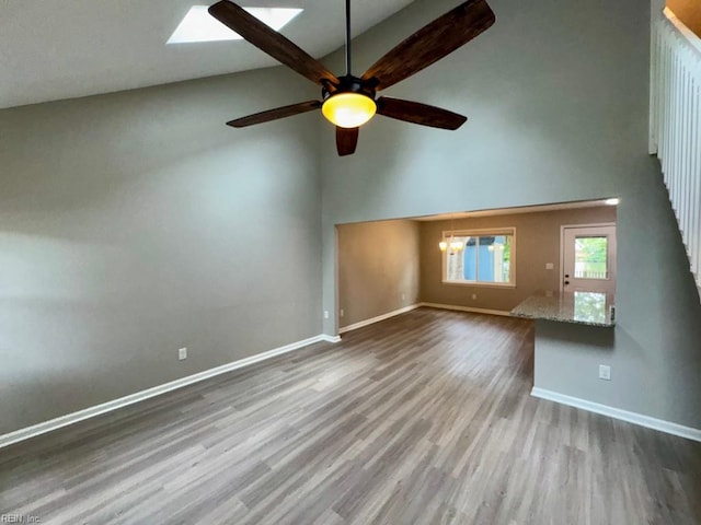 2020 Lyndora Rd, Virginia Beach, VA 23464 - unfurnished living room with high vaulted ceiling, a ceiling fan, wood finished floors, and a skylight