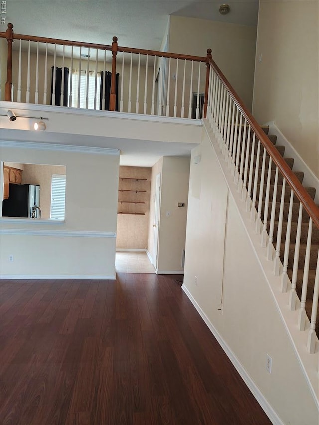 419 Adkins Arch Arch, Virginia Beach, VA 23462 - unfurnished living room with a high ceiling, wood finished floors, and stairway